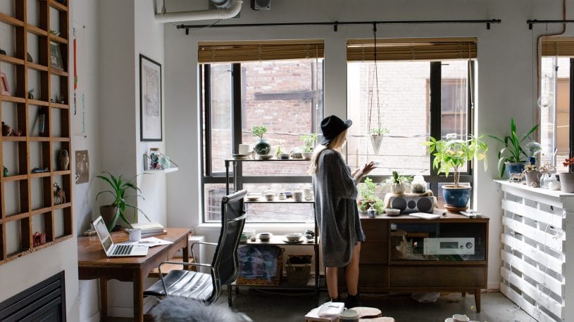 A woman standing in her apartment